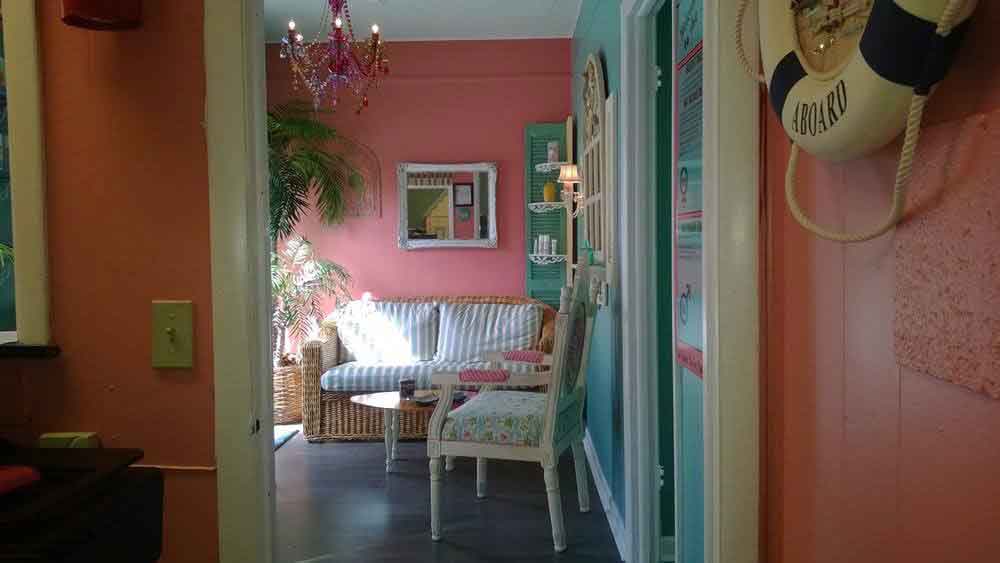 Waiting area with settee and hallway through to the treatment rooms