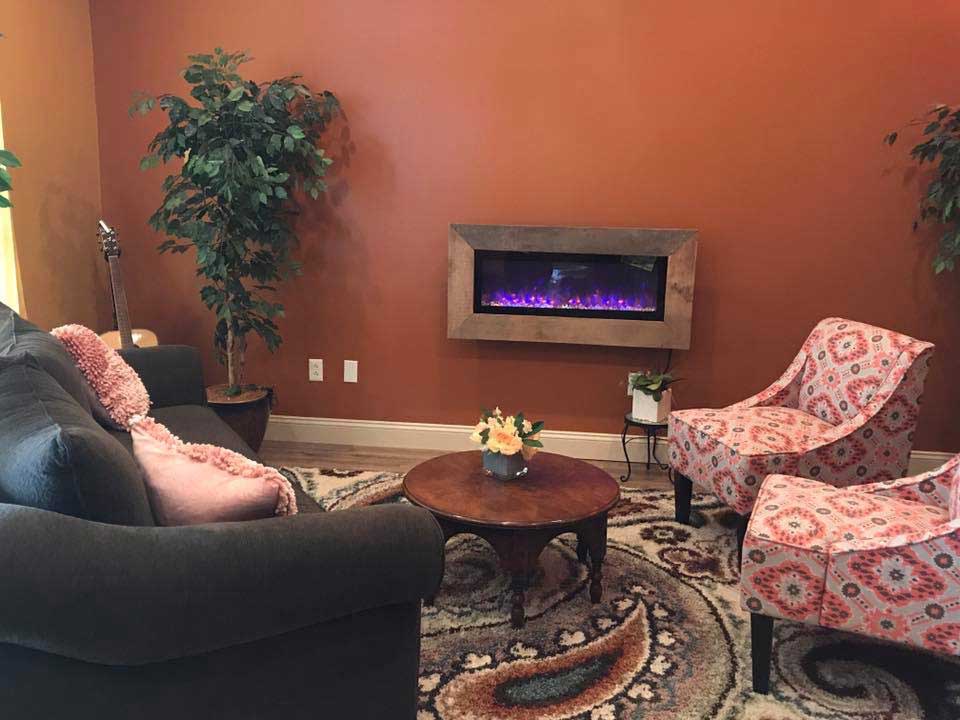 Studio lounge with fireplace and armchairs
