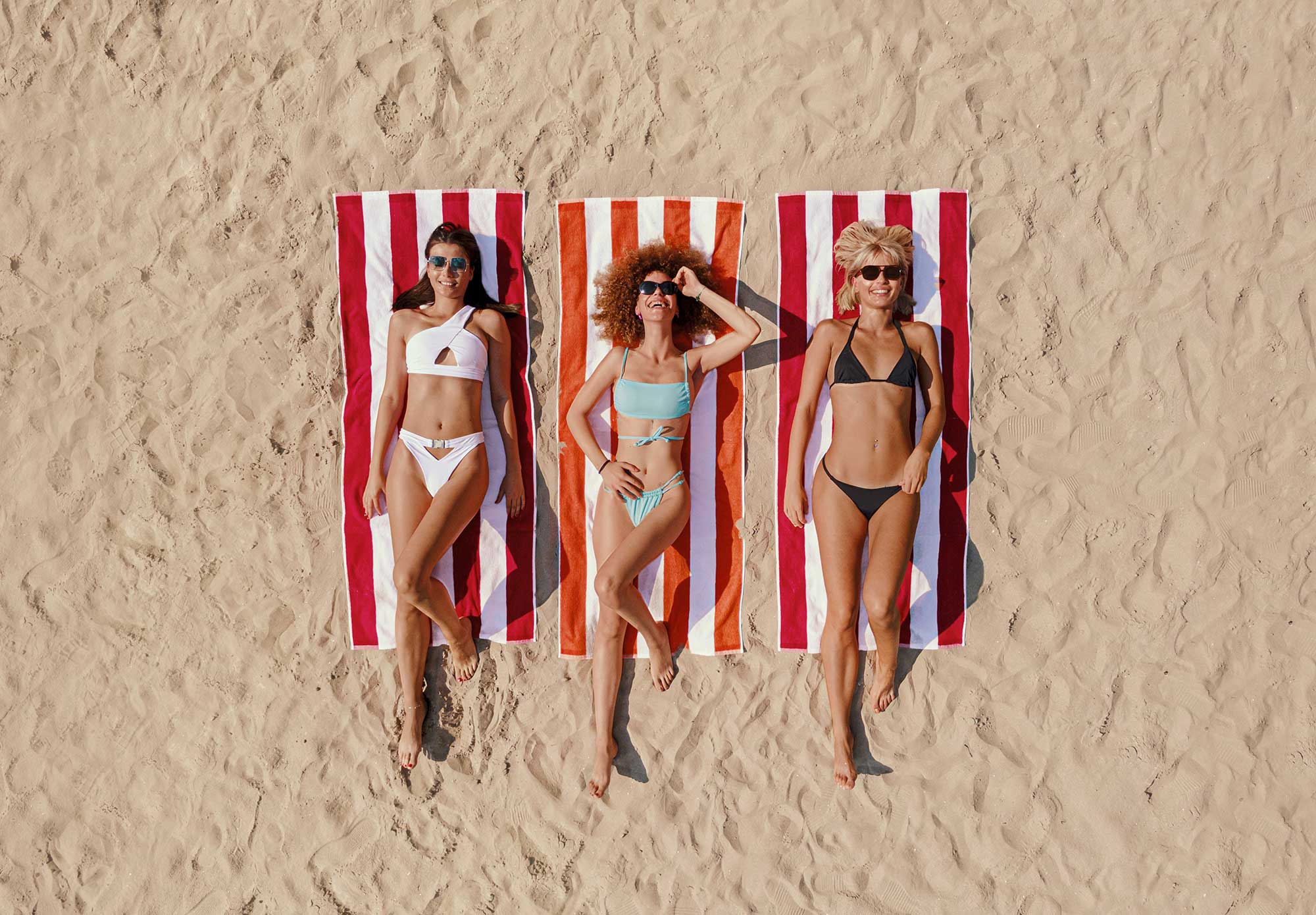 Three clients on the beach after full body waxing